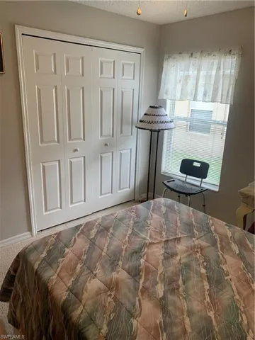 Bedroom with a closet and a textured ceiling