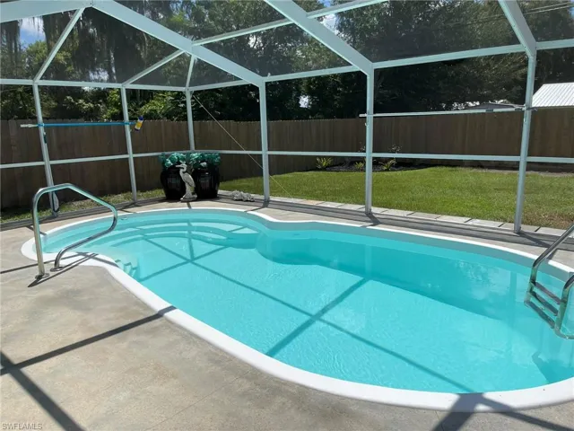 View of pool with a lanai and a patio area