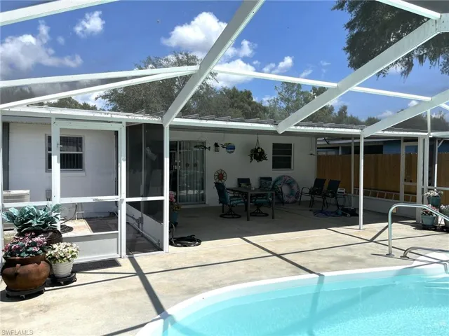 View of swimming pool with a patio area and a lanai