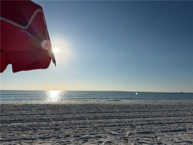 Relaxing under the umbrella on the sugar sand