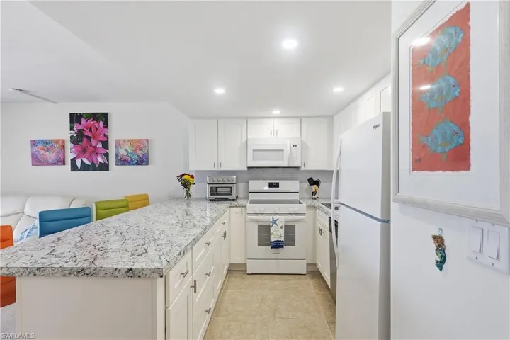 Lots of cabinets and drawers making a spacious kitchen and lots of countertops.