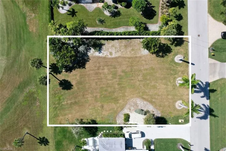 Aerial view of property and surrounding area featuring property parcel outlined