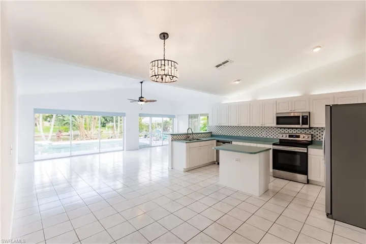 Kitchen with plenty of natural light, stainless steel appliances, and light tile patterned flooring