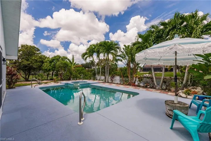 View of pool with a patio area and an in ground hot tub