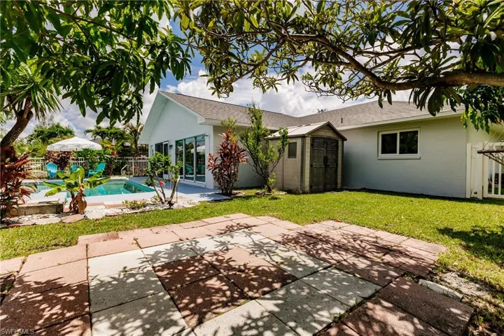 Rear view of house featuring a lawn and a patio