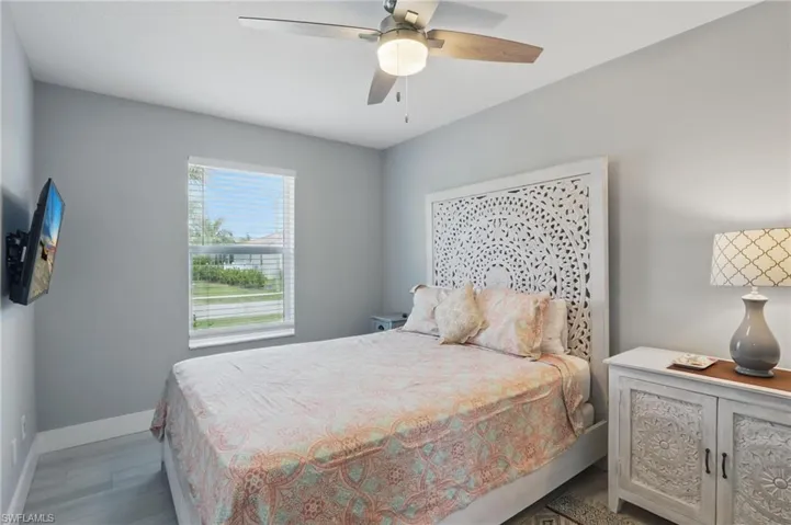 Bedroom with baseboards, a ceiling fan, and wood finished floors