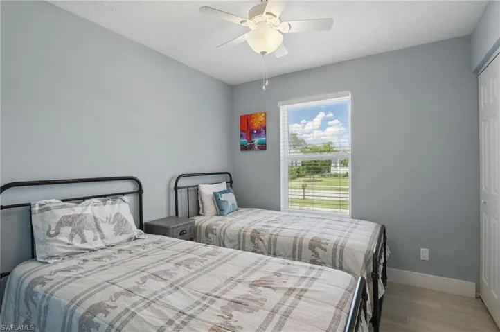 Bedroom with baseboards, a ceiling fan, and wood finished floors