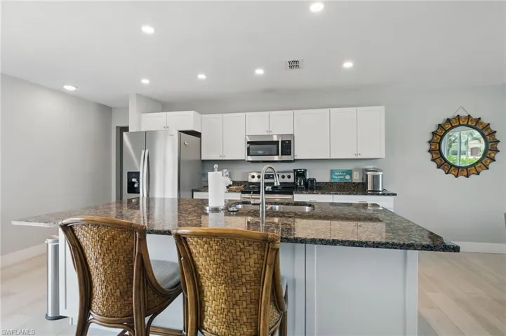 Kitchen featuring recessed lighting, stainless steel appliances, baseboards, and a sink