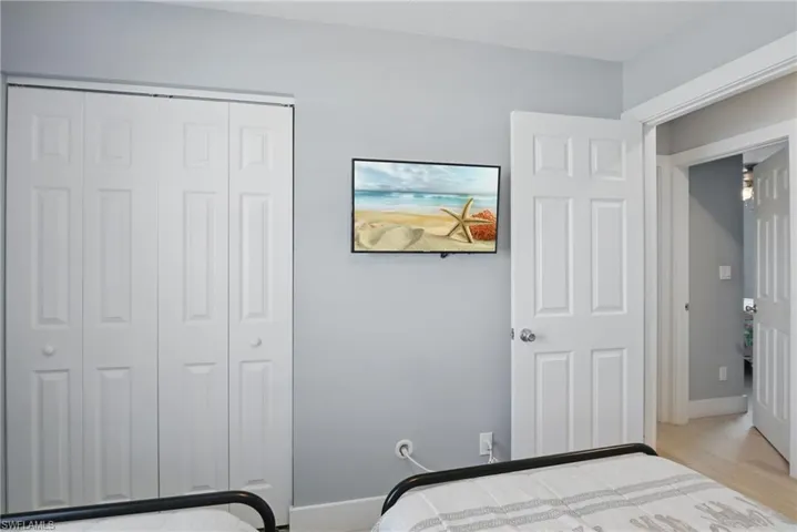 Bedroom featuring a closet, baseboards, and wood finished floors