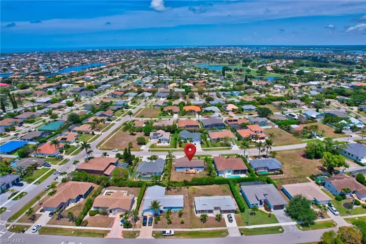 Birds eye view of property with a water view and a residential view
