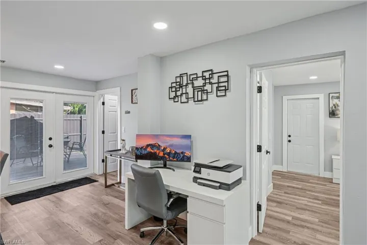 Office featuring french doors, light wood-type flooring, and recessed lighting