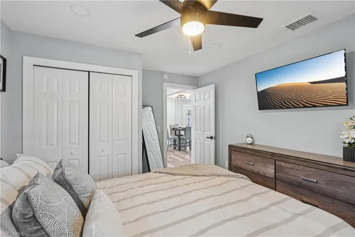 Bedroom with a ceiling fan and a closet