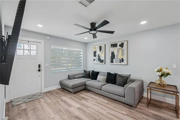 Living area featuring recessed lighting, light wood finished floors, and a ceiling fan