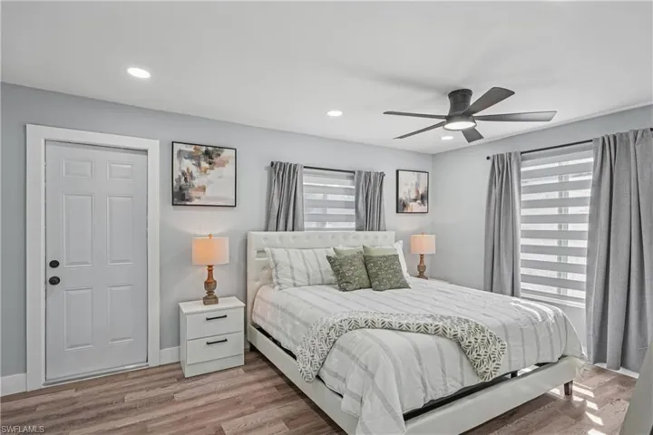 Bedroom with wood finished floors, ceiling fan, and recessed lighting