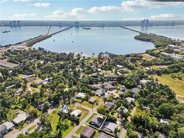 Aerial view of property and surrounding area featuring a notable bridge, nearby suburban area, and property boundaries highlighted