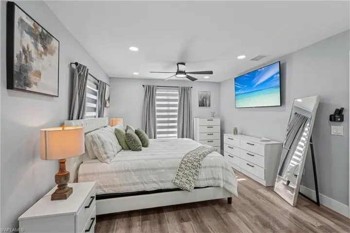 Bedroom featuring ceiling fan, light wood-style floors, and recessed lighting
