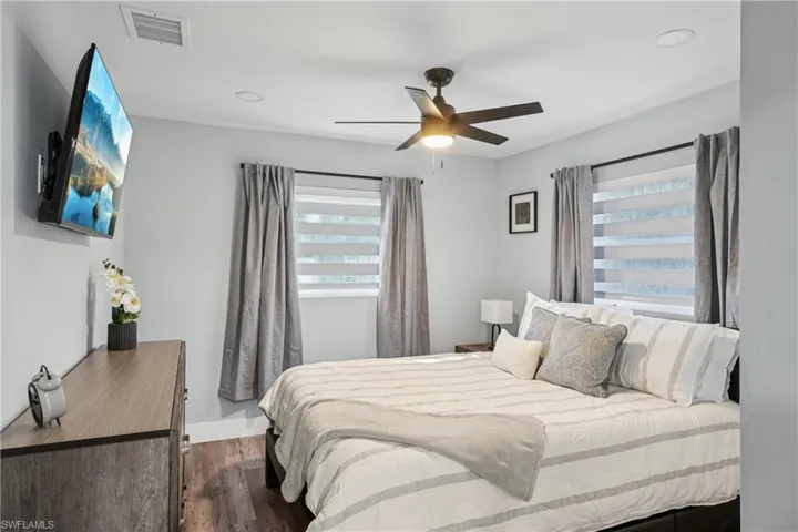 Bedroom with dark wood finished floors, recessed lighting, and ceiling fan