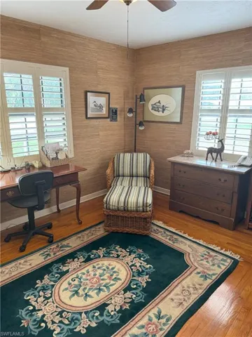 Living area featuring ceiling fan and hardwood / wood-style flooring