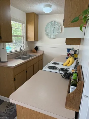 Kitchen featuring sink and a textured ceiling