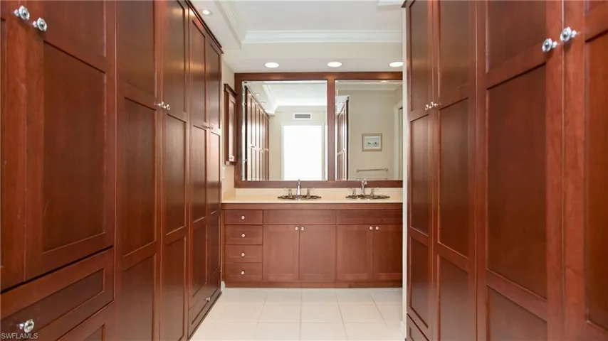 Bathroom with vanity and custom closets and organization