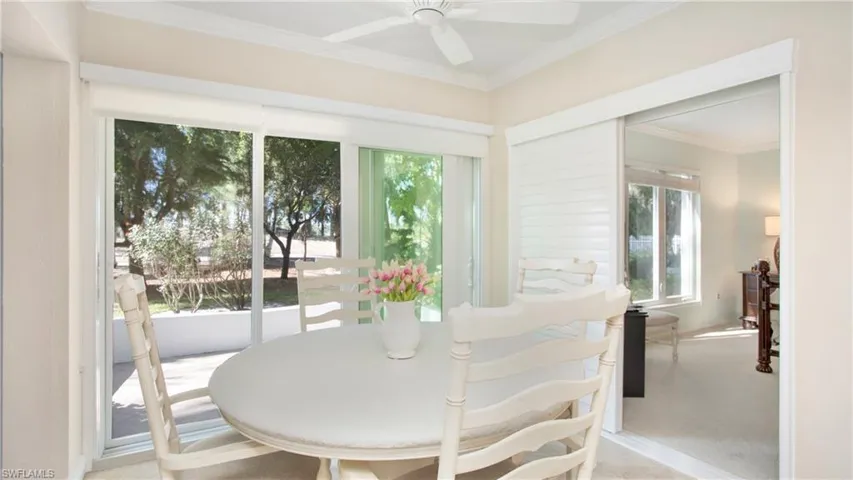 Sunroom / solarium featuring ceiling fan