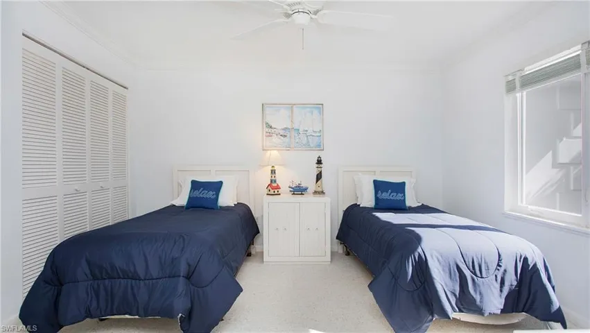 Bedroom with ceiling fan, crown molding, and a closet