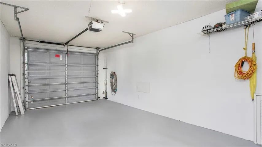 Garage featuring a garage door opener