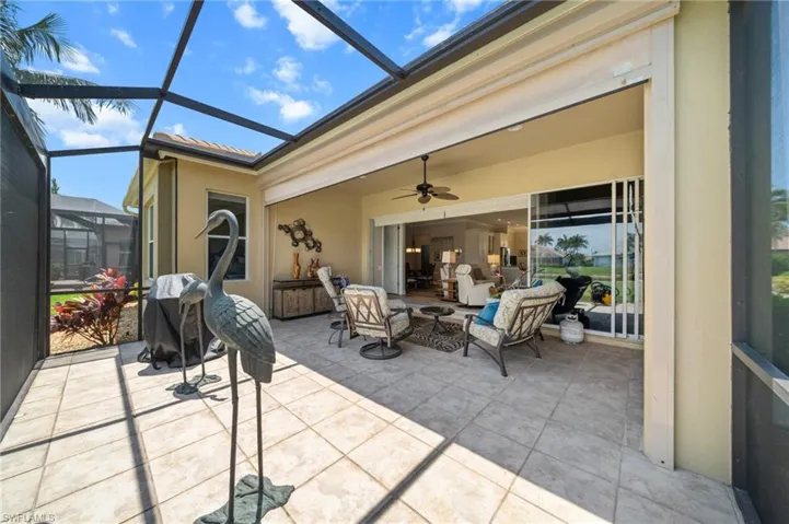 View of patio / terrace with a lanai, a ceiling fan, and outdoor lounge area