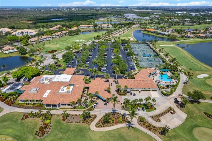 Aerial view of property's location featuring a local golf course, a nearby body of water, and nearby suburban area