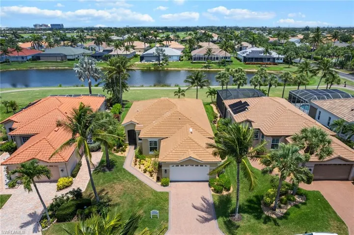 Aerial perspective of suburban area featuring a large body of water