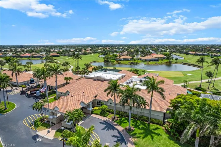 Aerial view of residential area with a golf course and a nearby body of water