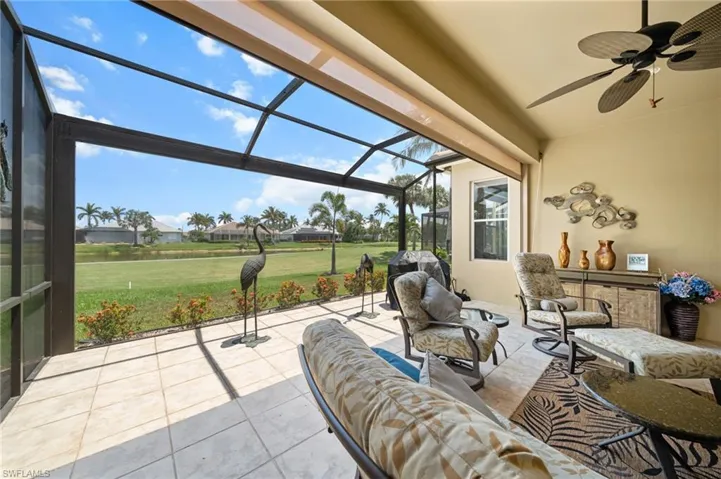 View of patio featuring outdoor lounge area, a ceiling fan, and glass enclosure