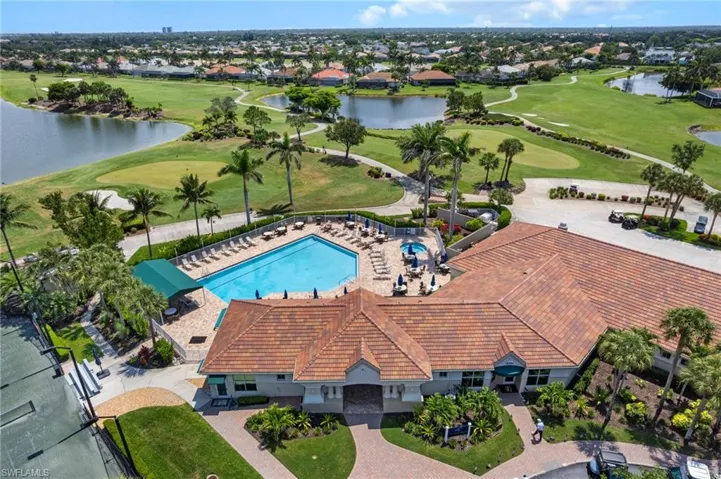 Aerial perspective of suburban area with a large body of water, a local golf course, and a pool area