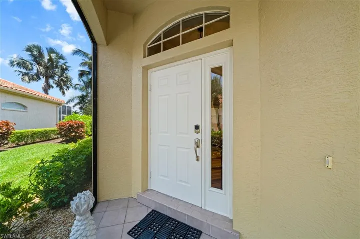 Entrance to property with stucco siding