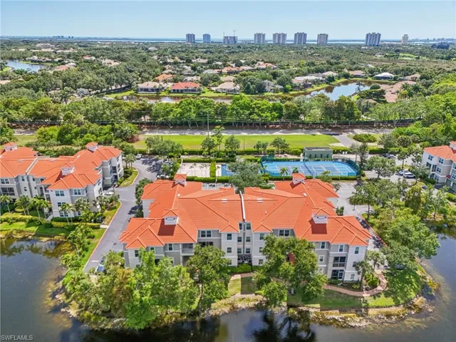 Birds eye view of property with a water view