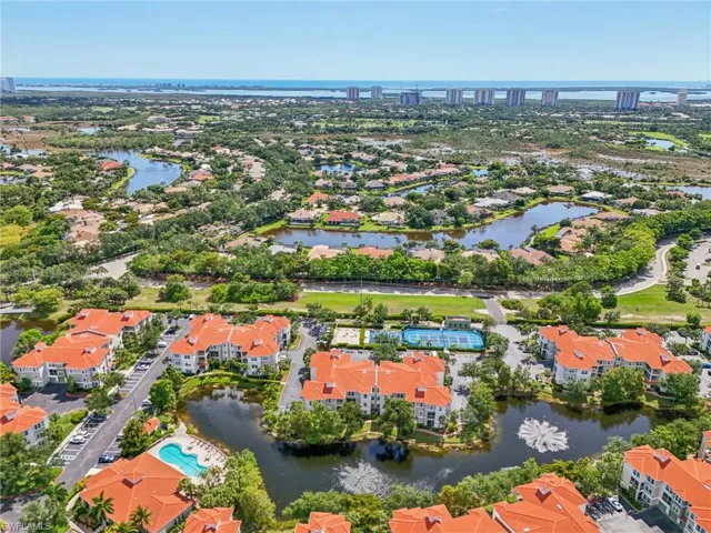 Birds eye view of property with a water view