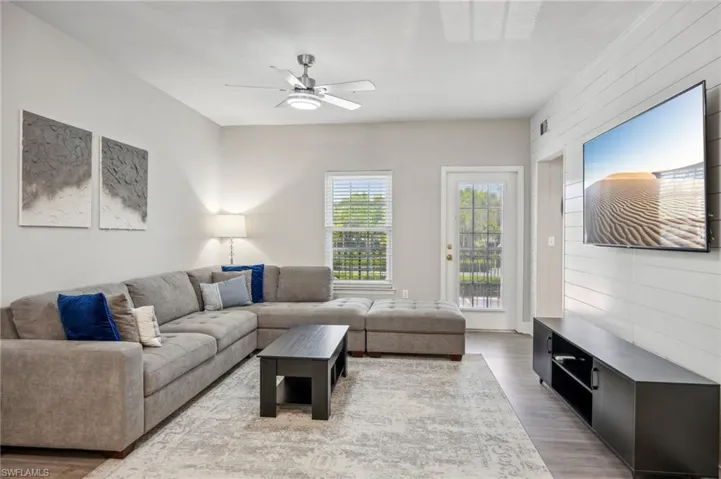 Living room with hardwood / wood-style floors and ceiling fan