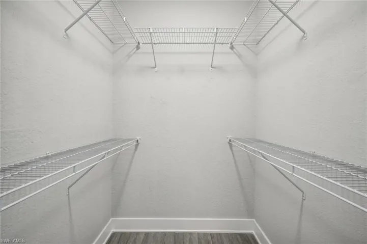 Spacious closet with wood-type flooring