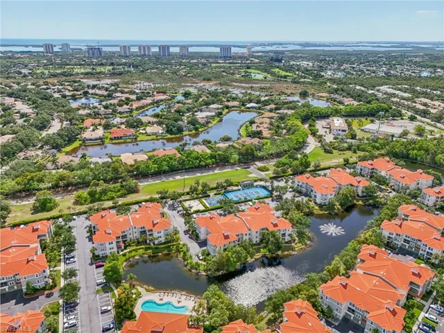 Birds eye view of property with a water view