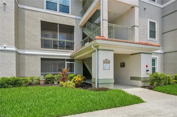 View of front of home featuring a front yard and a balcony
