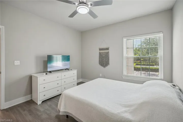Bedroom with ceiling fan and wood-type flooring
