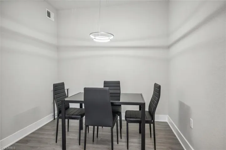 Dining area with dark hardwood / wood-style floors