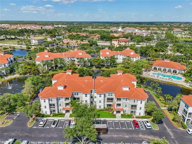 Birds eye view of property with a water view