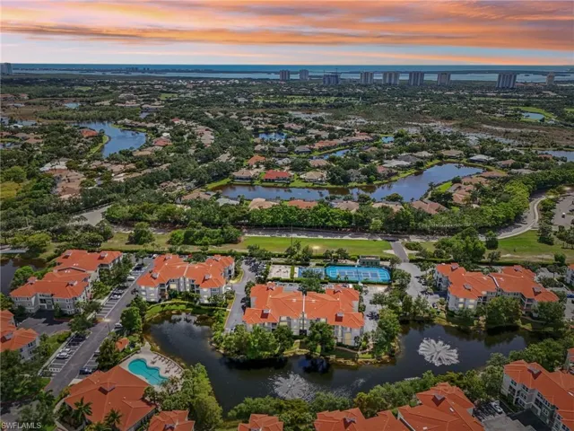 Aerial view at dusk featuring a water view