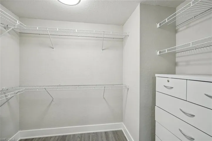 Spacious closet with hardwood / wood-style floors