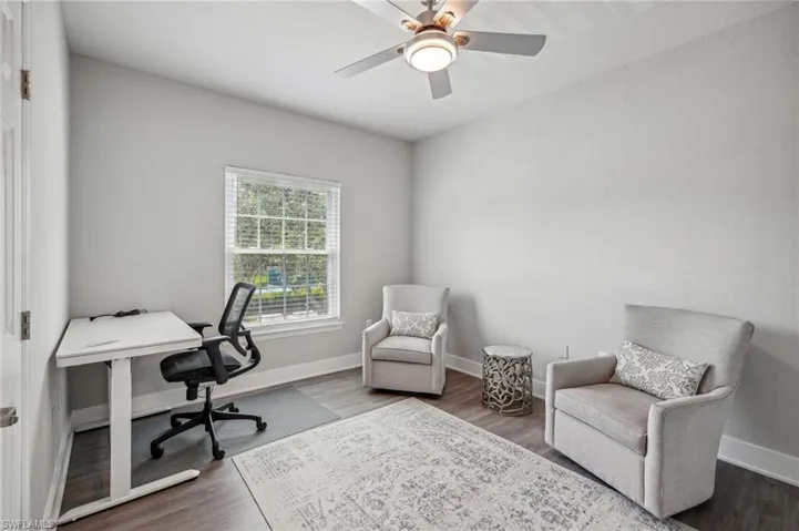 Office with hardwood / wood-style flooring and ceiling fan