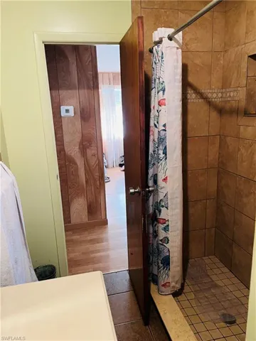 Bathroom featuring tile patterned flooring and a shower with curtain