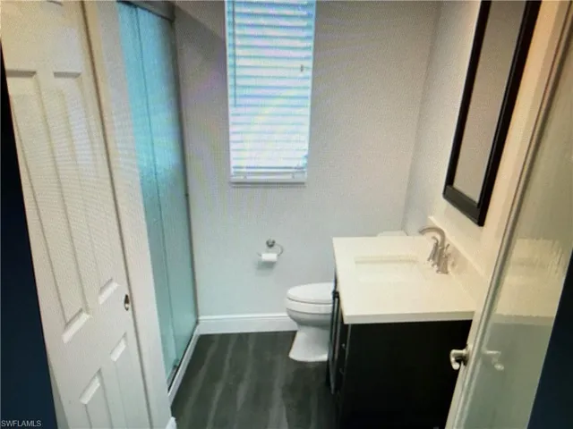 Bathroom featuring vanity and dark wood-type flooring