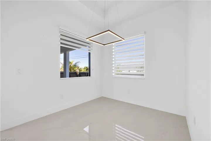 Spare room featuring baseboards and marble finish floor