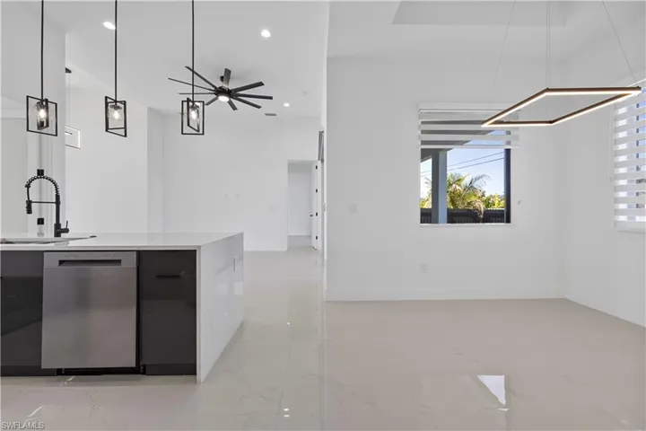 Bar with a sink, dishwasher, recessed lighting, and hanging light fixtures